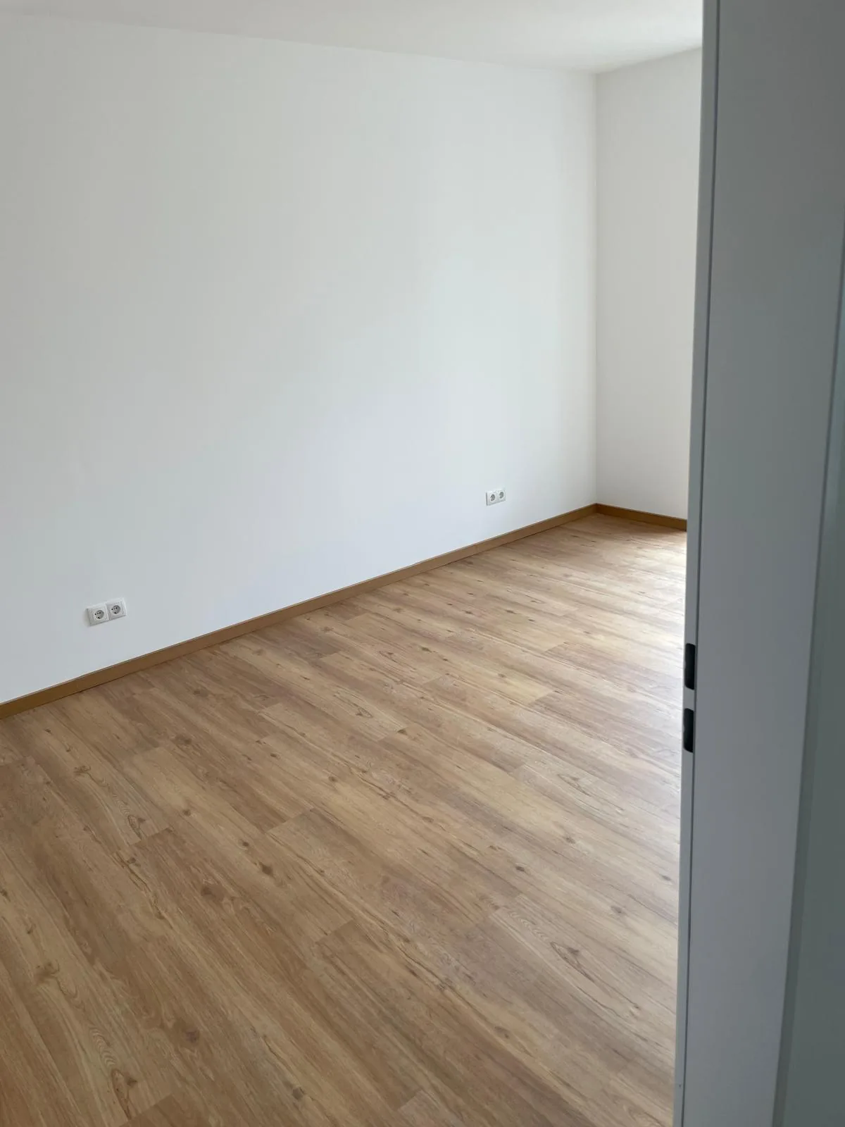 Von Barzel Raumgestaltung sauber verlegter Vinylboden in einem hellen Wohnraum
